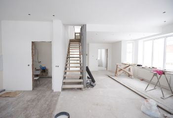 Open-concept living room renovation in La Canada Flintridge featuring modern staircase and recessed lighting"