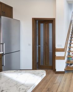 Living room transformation featuring modern staircase elements and cohesive design